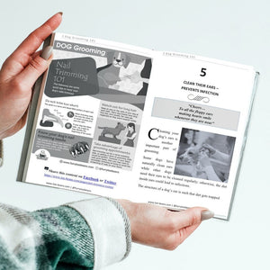 Person holding dog and cat grooming 101 dog book Looking inside by Toe Beans
