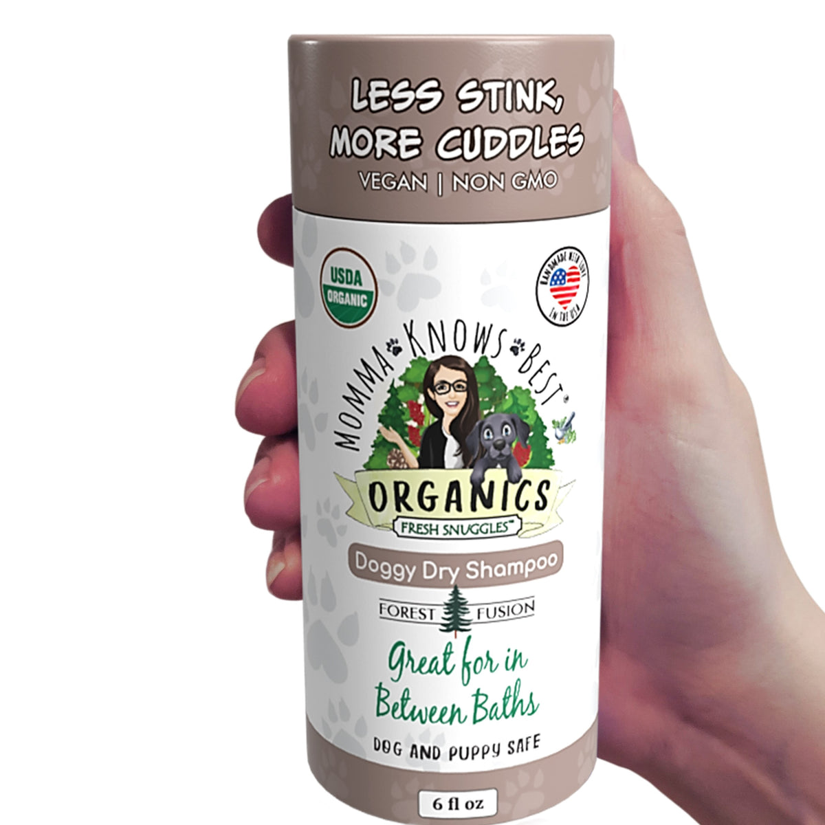 A hand holding a no rinse dog shampoo by Momma Knows Best Forest Fusion