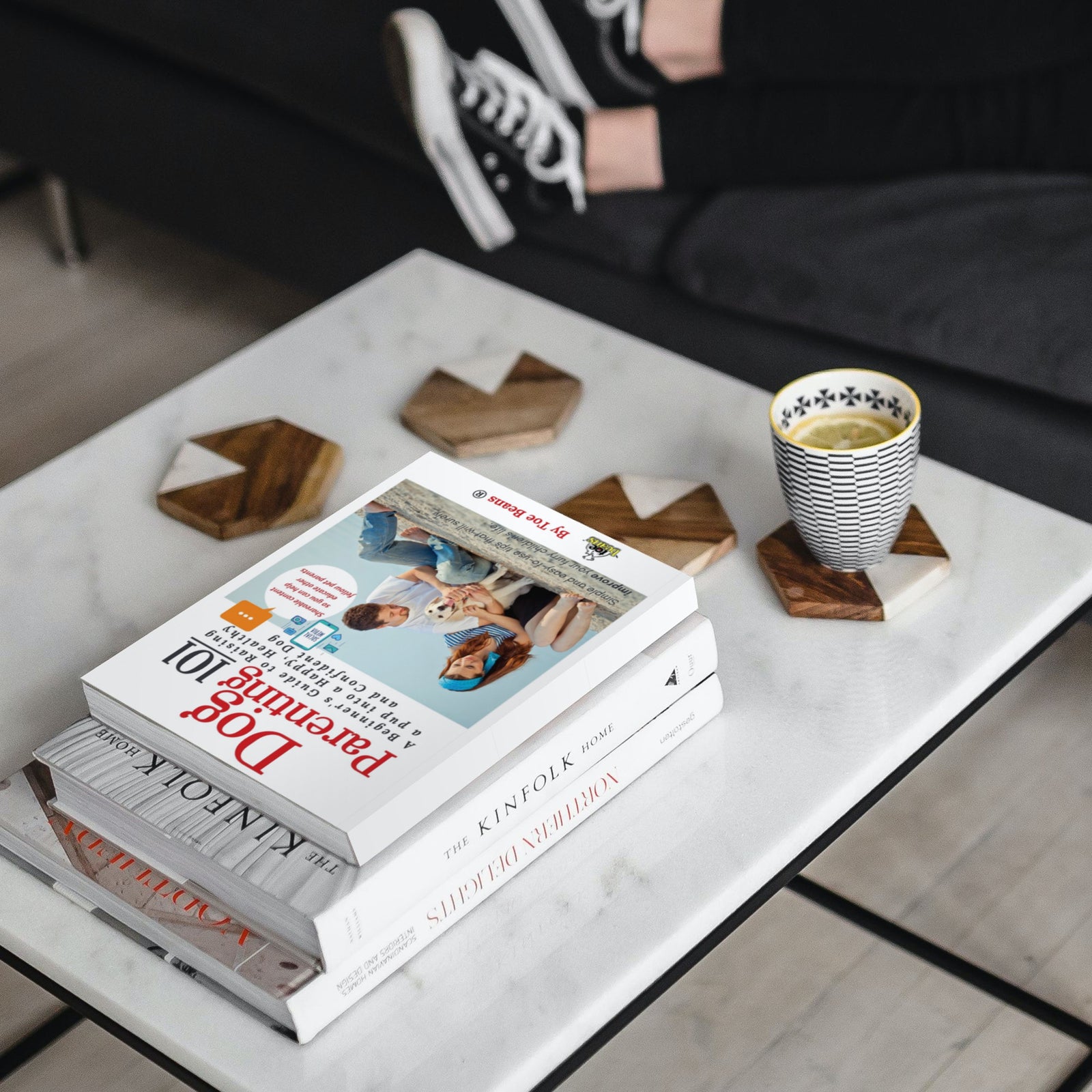 Dog Parenting 101 Dog Book by Toe Beans® on stack of books