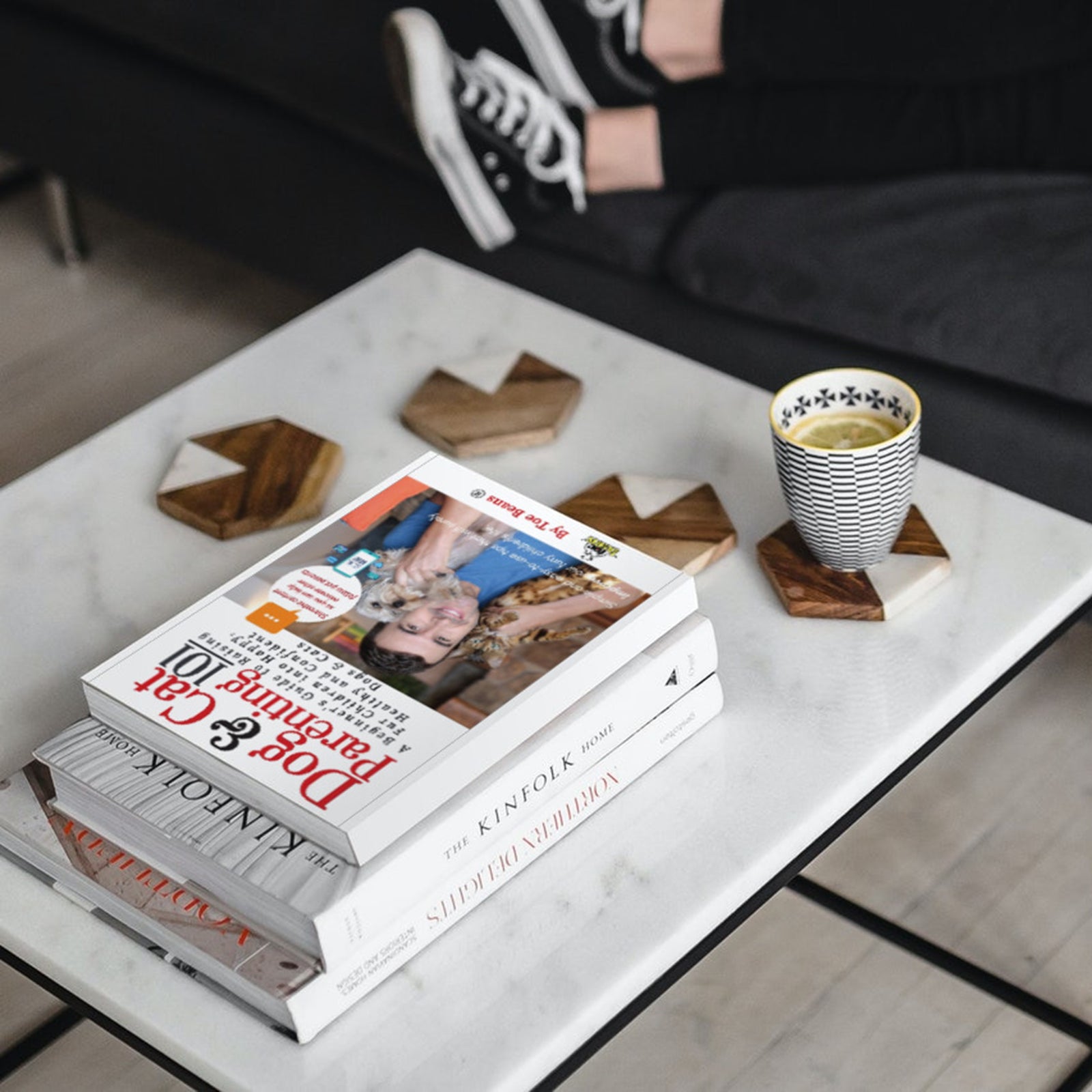 Dog and cat Parenting 101 pet Book by Toe Beans® on stack of books